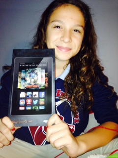 Emily H., winner of the Cool Word Club's Cool Points Contest, shows off her new Kindle Fire HD. 